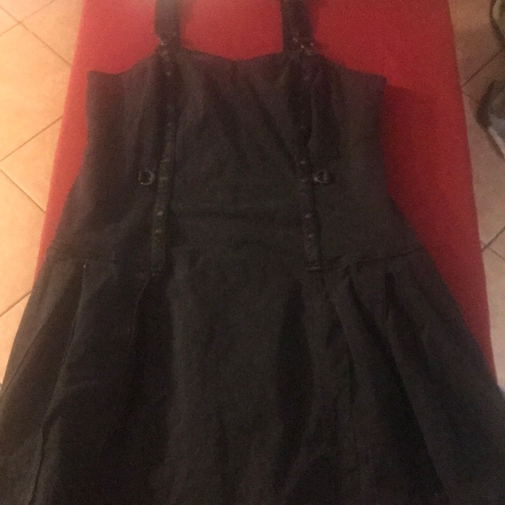 A black Tripp bucket overalls dress